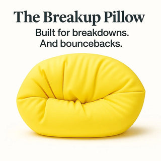 Yellow pillow with text 'The Breakup Pillow: Built for breakdowns. And bouncebacks.' on a white background