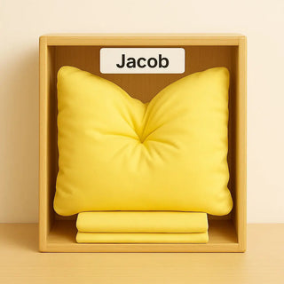 Yellow bamboo cloud technology pillow and folded cloud case covers in a daycare cubbie with 'Jacob' label on a beige background.