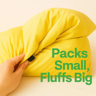 Yellow pillow being compressed with text 'Packs Small, Fluffs Big' on a beige background