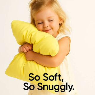 Child hugging a yellow cloud technology pillow with 'So Soft, So Snuggly' text on a light background